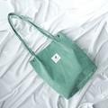 Mint green corduroy tote bag with adjustable shoulder strap and woven square label - Matcha Green
