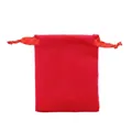 Close-up of red velvet drawstring pouch with silk ribbons for jewelry storage - Red