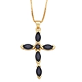 Detail of a gold cross pendant necklace featuring black marquise-cut stones on box chain - Black