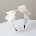 Chic white bow headband made of textured fabric on a transparent acrylic stand - Large Bow (FK-B299 Beige)
