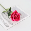 Single red velvet artificial rose on an open magazine for home wedding decor - Large Velvet Light Rose Red