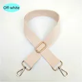 Close-up of adjustable beige canvas bag strap with durable gold metal swivel hooks - Off-white