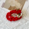 Handmade knitted Christmas hair clip with a gingerbread man design on a red oval base - Hollow Oval Gingerbread Man Hair Clip