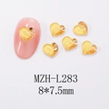 Detail of heart-shaped golden resin nail charms with metallic edges on pink nails - L283-Golden Yellow Heart with Gold Border