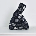 Detail of navy linen knot bag with cat patterns and long handle loop closure - White Cat on Blue