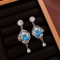 Macro detail of silver butterfly earrings with blue enamel and crystal teardrop pendants - Silver-Teardrop (28# Silver Earring Post - Silver-Teardrop)