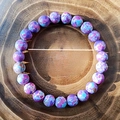 8mm purple and blue imperial stone bead bracelet presented on natural wood ring background - Imperial Turquoise
