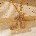Minimalist 18K gold plated necklace with iced-out letter K pendant on stone base - Letter K
