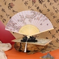 Vintage style purple folding fan with cherry blossom pattern and white tassel on stand - Purple Grace