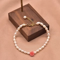 Elegant freshwater pearl bracelet featuring a pink rose pendant and gold clasp on silk - Pink Flower Embossed Bracelet Set
