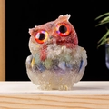 Resin owl figurine with natural crushed crystals and striking orange eyes on wood - 7 Chakras Multicolor