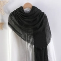 Solid black crinkle cotton linen scarf with frayed edges styled on a white shirt - Black