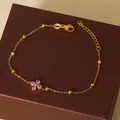 Elegante gouden titanium stalen armband met roze zirkoon klavertje vier en metalen kralen - Goud Roze Zirkoon Klaver