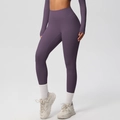 Close-up of dark purple high-waisted yoga leggings with wide waistband for tummy control - Eggplant Purple