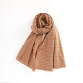 Close-up of brown and beige houndstooth scarf with soft fringe details and texture - 2.00cm / Camel