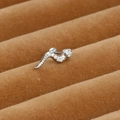 Detailed macro view of a silver snake cartilage earring with cubic zirconia inlay - Snake Style