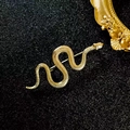 Vintage luxury golden snake brooch with detailed scales and a textured finish - Gold