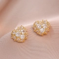 Elegant gold heart stud earrings featuring micro-pave cubic zirconia on silk background - 3D Heart Style (E0922) / Gold