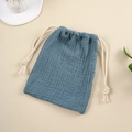 Detailed texture of muslin cotton drawstring bag in fog blue with natural gauze wrinkles - Sapphire Blue