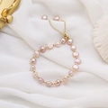 Detailed macro of irregular purple freshwater pearls with gold beads on white silk - 21# Baroque Freshwater Pearl Bracelet