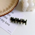 Cute black acrylic cat hair clip with gold metal base on a white display card - Dark Green Dog