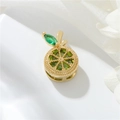 Macro view of 14k gold-plated orange pendant with green crystals on white floral lace - H-10731 Orange