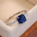 Elegant silver ring featuring a cushion-cut royal blue zircon with pave diamonds - Royal Blue