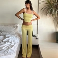 Detailed close-up of yellow two-piece lace crop top and high-waisted wide-leg trousers - S / Yellow