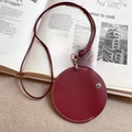 Dettaglio della collana portaocchiali in pelle rosso scuro con cuciture bianche e bottone a scatto - Stile Rotondo / Rosso anfora