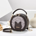 Brown round crossbody bag with cat ear design and silver glitter on a studio background - Coffee