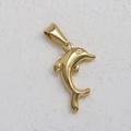 Detailed view of a 24K gold plated stainless steel dolphin pendant on a textured surface - BK03-Dolphin 1-Gold