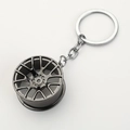 Car wheel rim keychain in gunmetal finish made of premium metal with flat white background - Gunmetal