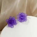 Macro detail of purple matte translucent flower earrings on a white elegant pedestal - Purple