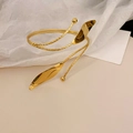 Detailed macro view of gold-plated leaf bangle with spiral texture and elegant leaf charms - Style 1 / Gold Leaf Style