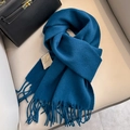 Dark blue 100% Australian wool scarf featuring elegant tassels on a soft leather surface - Deep Navy Blue