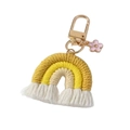 Detailed shot of handmade woven rainbow keychain with cotton fringes and flower charm - Bright Yellow