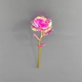 Artificial rose with colorful holographic petals and golden stem on a textured background - Rose Red