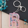 Letter R keychain featuring pink glitter and star sequins with a silver lobster clasp - Letter R
