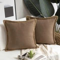 Close-up of brown linen pillow cover with woven rope trim on a white sofa with a throw - Coffee