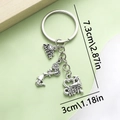 Silver cheerleading keychain with I Love To Cheer heart and megaphone charms - Sports Cheerleader Girl