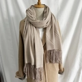 Beige herringbone scarf with fringes shown on a wooden mannequin over a camel coat - 32# Twill Beige