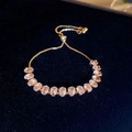 Macro shot of rose gold bracelet featuring pink oval gems and adjustable sliding buckle - Pink Zirconia Oval Adjustable Bracelet
