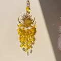 Detail of metal sun moon suncatcher with yellow crystal beads and light reflections - Yellow Sun