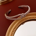 Detailed close-up of double-layer silver knot bracelet with sparkling zircon inlay - Silver