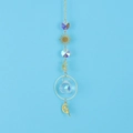 Detail of golden sun catcher featuring faceted crystal ball and celestial fairy pendants - Citrine