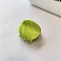 Close-up of a vibrant neon green tennis ball hair claw clip on a white wooden surface - Small Tennis-Green (5cm)