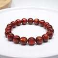 Macro shot of smooth red natural stone beads with gold foil texture on white display - 18# (Red Goldstone Texture)