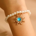 White pearl bracelet with golden sun pendant and blue gemstone inlay for women - Gold Light Blue Bracelet