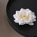 Elegant white fabric flower hair clip on a black tray for a minimalist bridal look - Pointed Rose / Cream