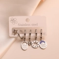 Detail of five silver stainless steel earrings featuring star and moon pendants on silk - Blue Moon Star Enamel Set